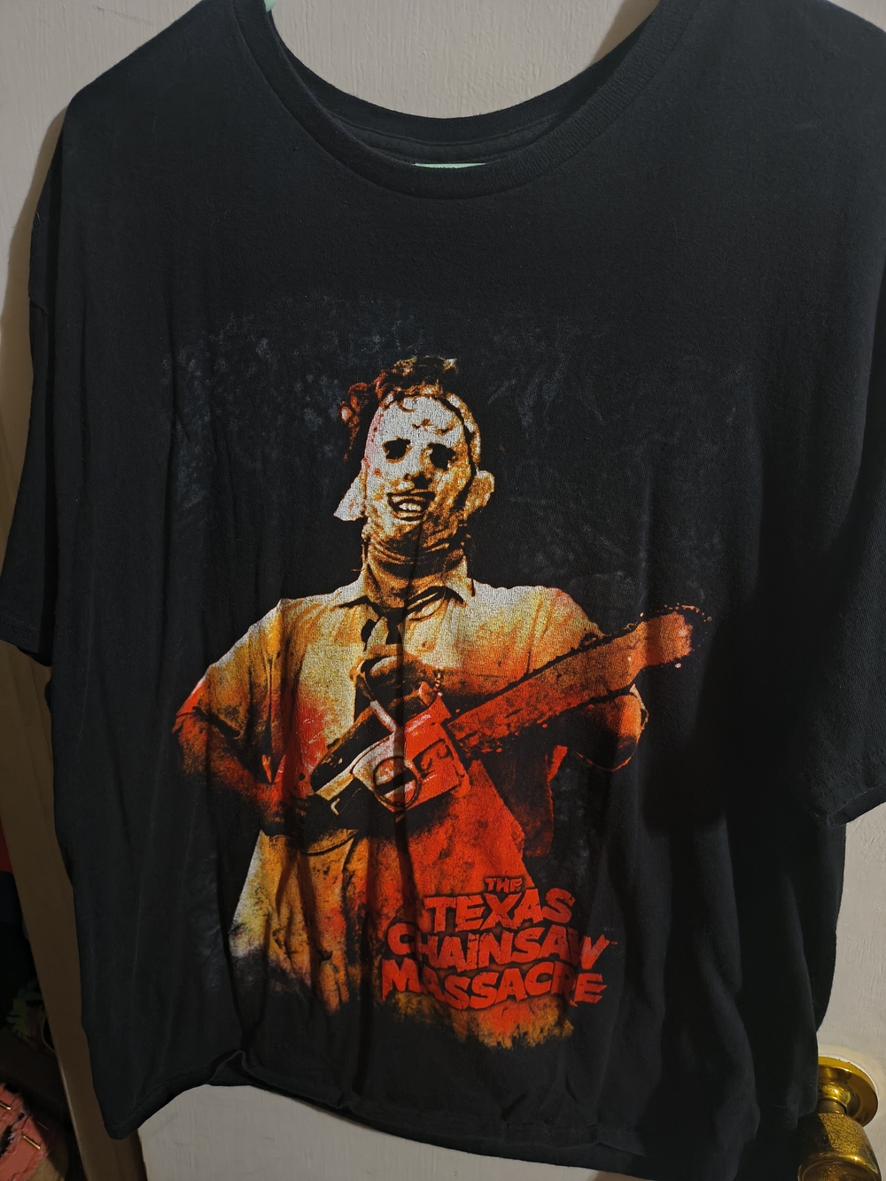 Black Short-Sleeve Graphic Tee with Orange-Red Texas Chainsaw Massacre Print